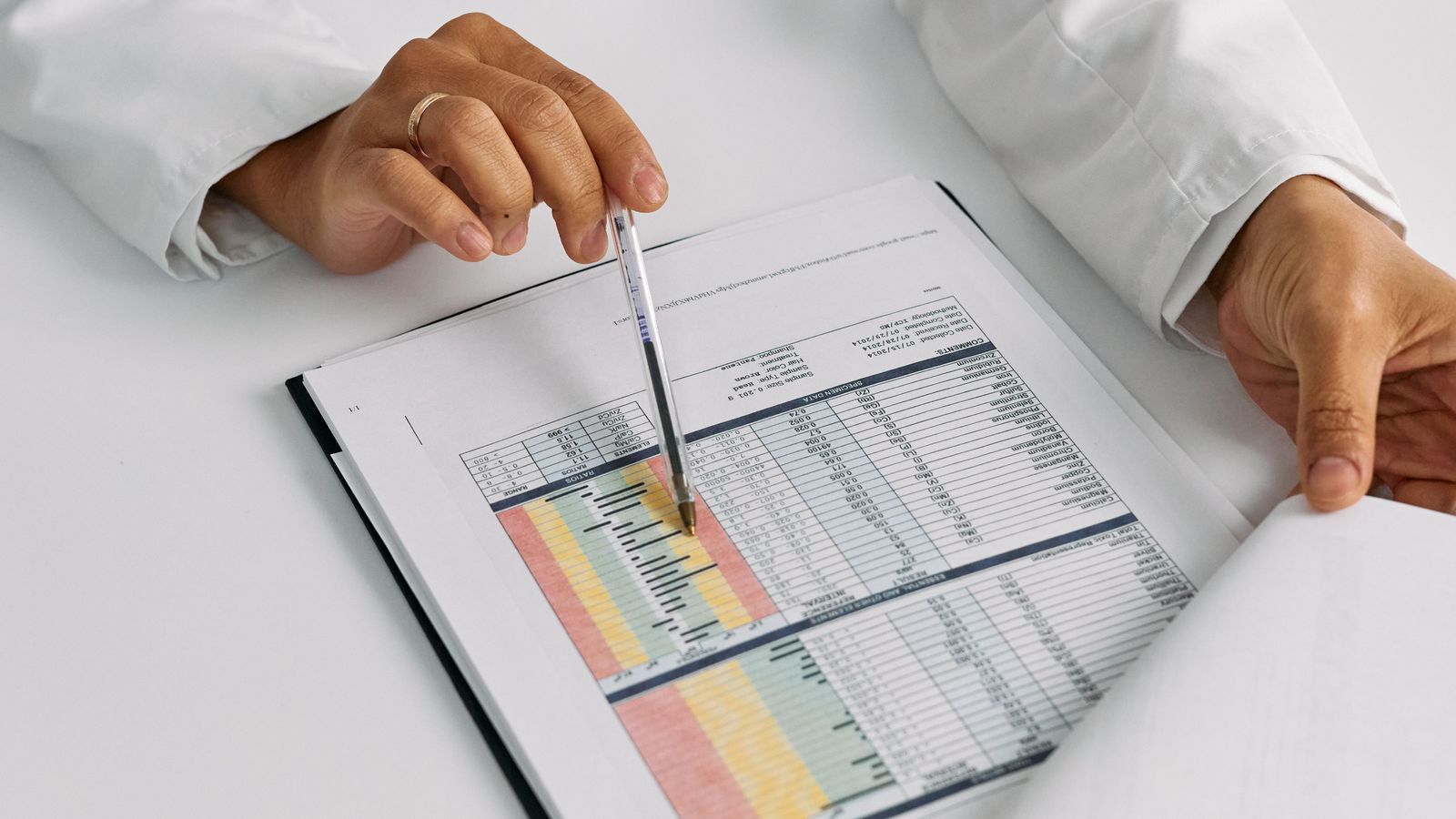 Doctor reviewing medical documents and charts at a desk